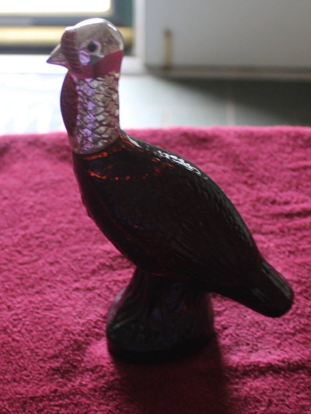 Vintage Avon Wild Turkey bottle, featuring brown glass and a silver-colored head